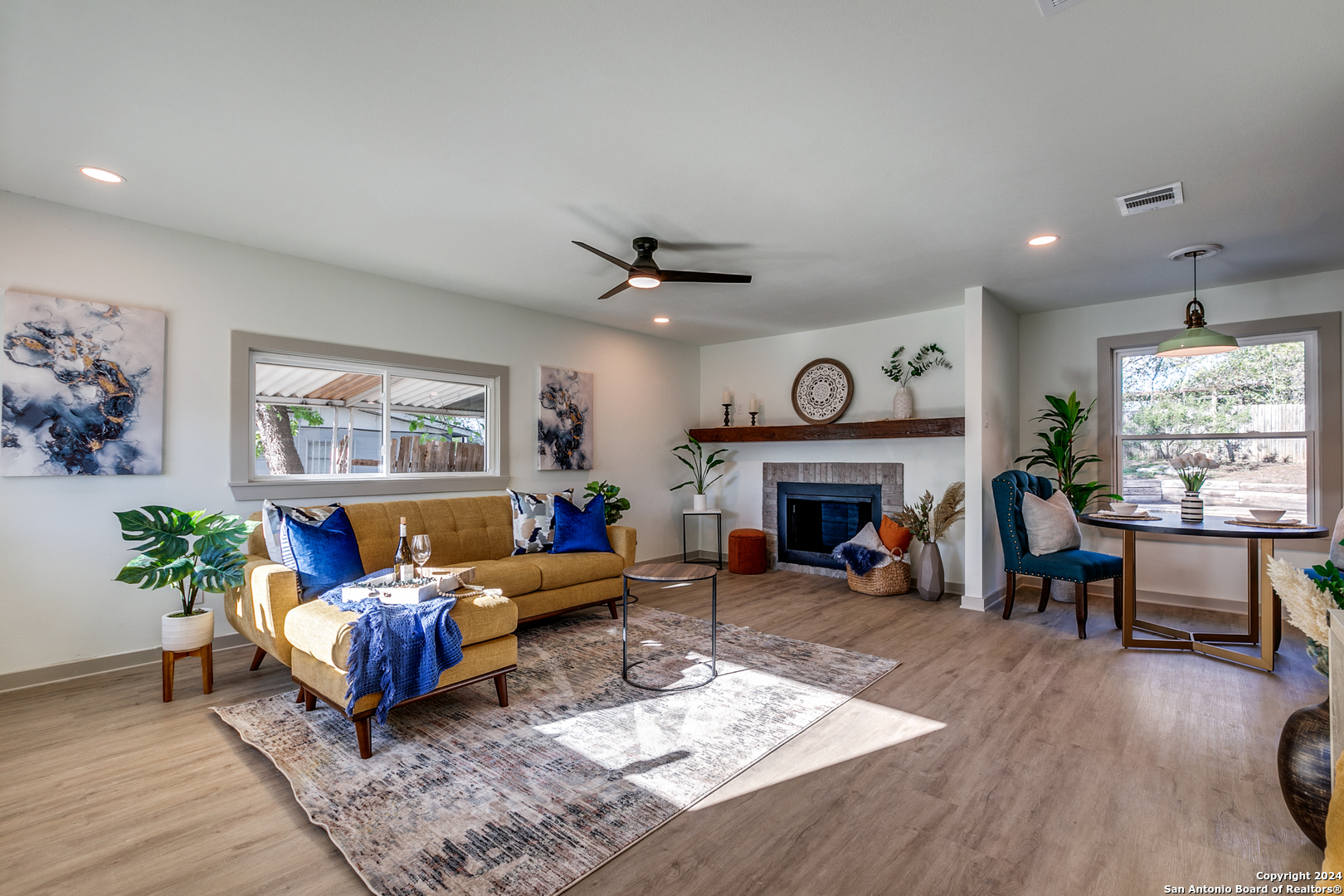 a living room with furniture fireplace and window