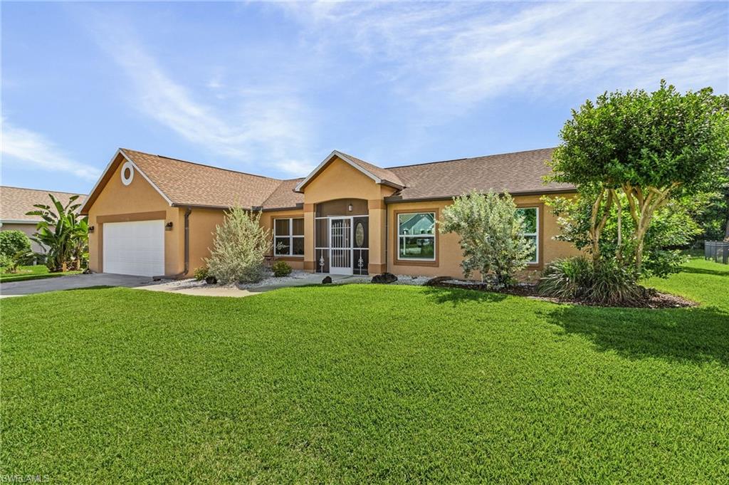 a front view of a house with a yard and green space