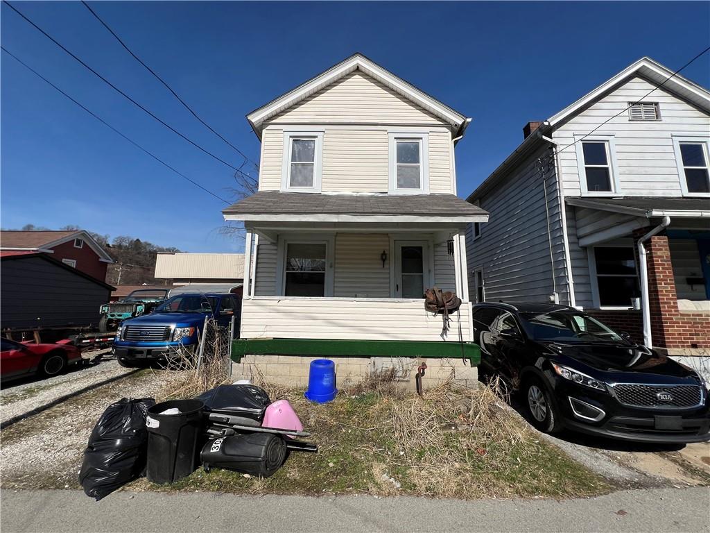 a view of a house with cars park