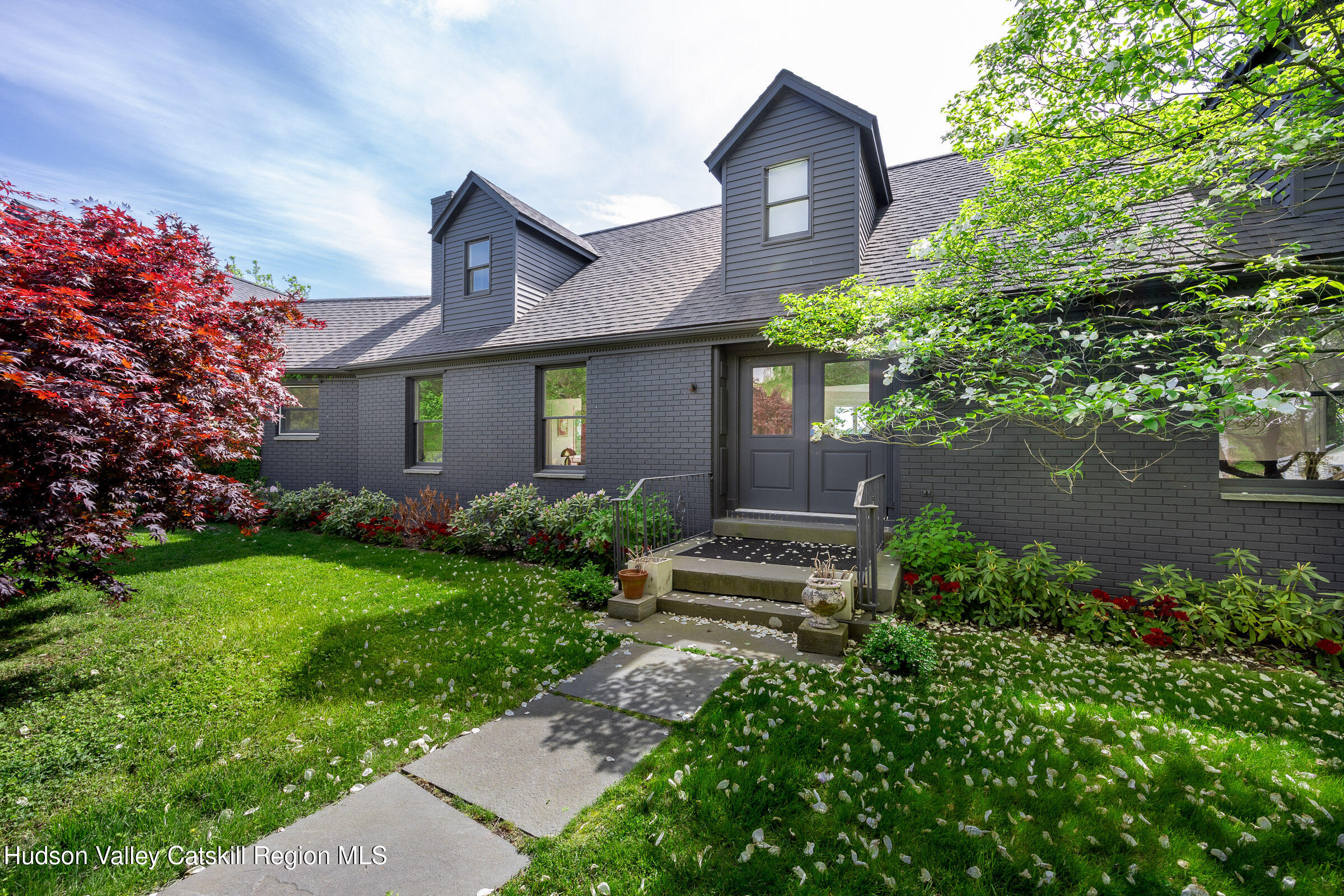 a front view of a house with garden