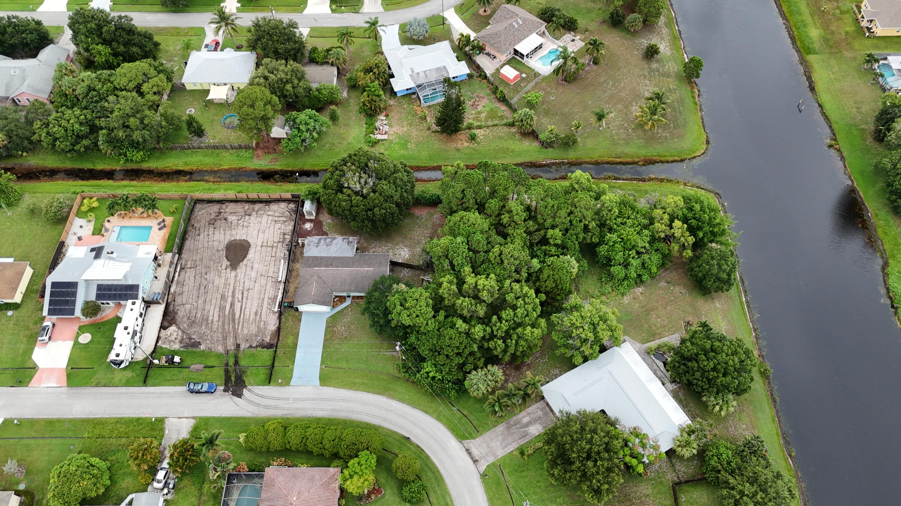 an aerial view of a residential houses with outdoor space and street view