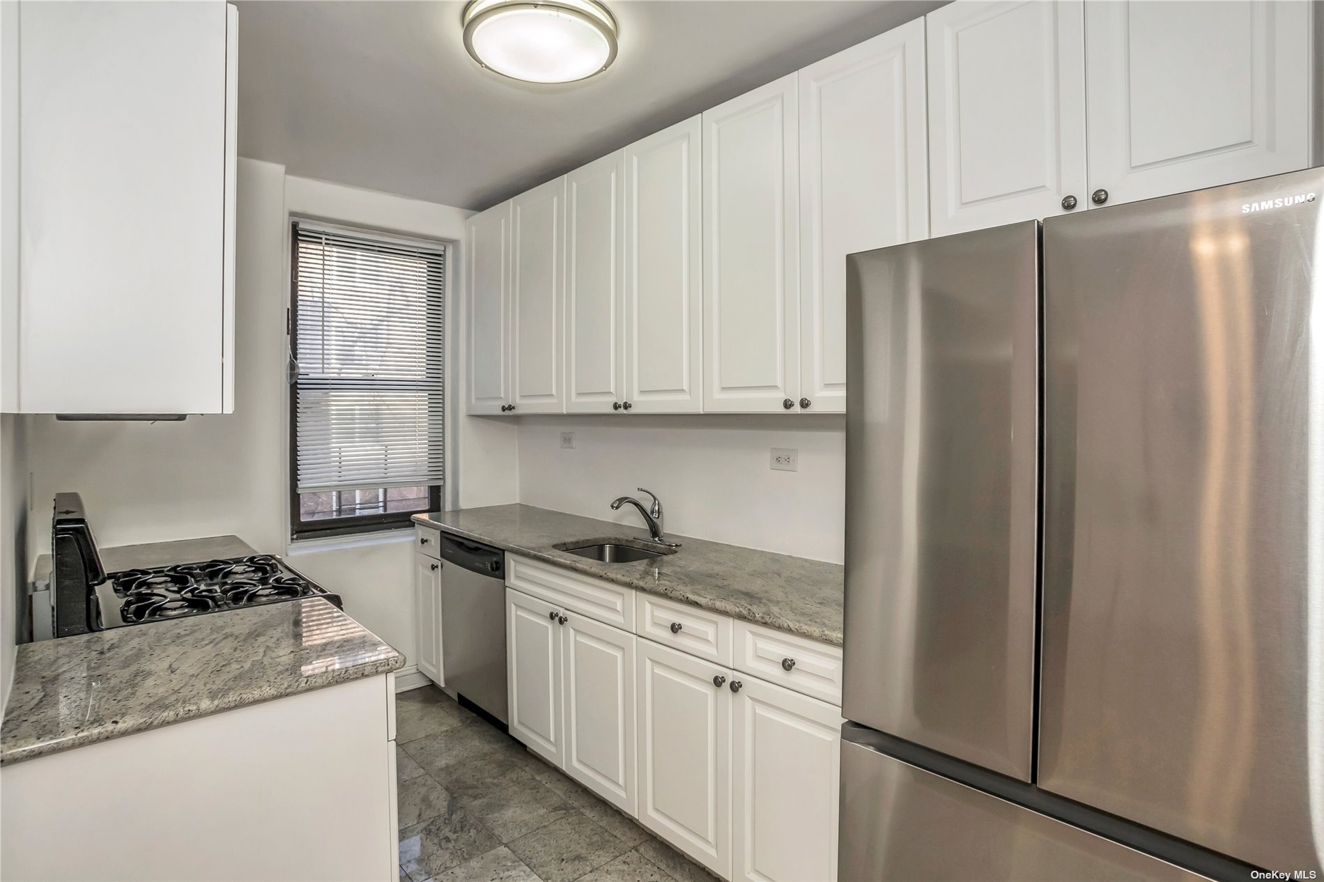 a kitchen with stainless steel appliances granite countertop a refrigerator sink and cabinets