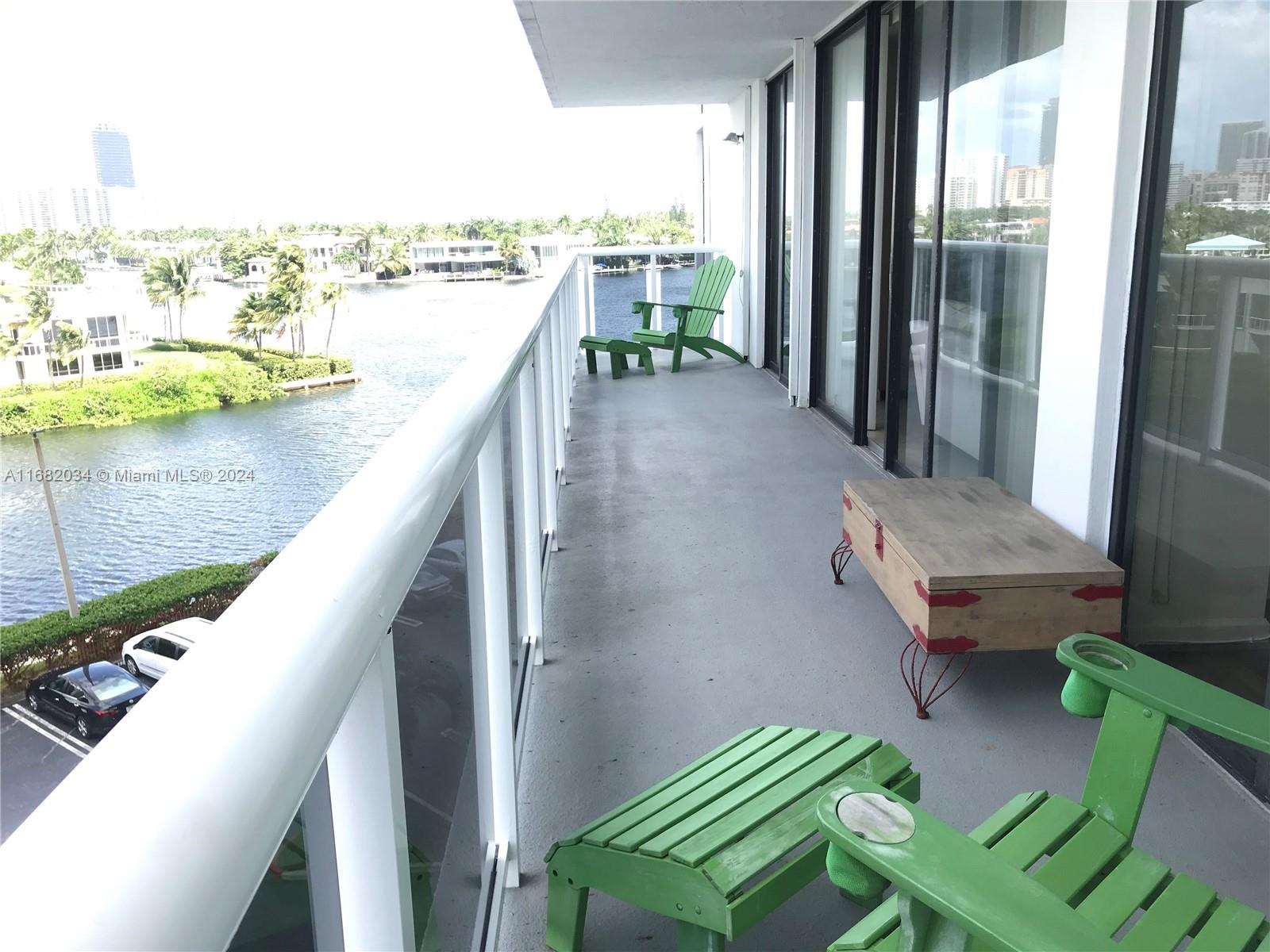 a balcony with outdoor seating and city view