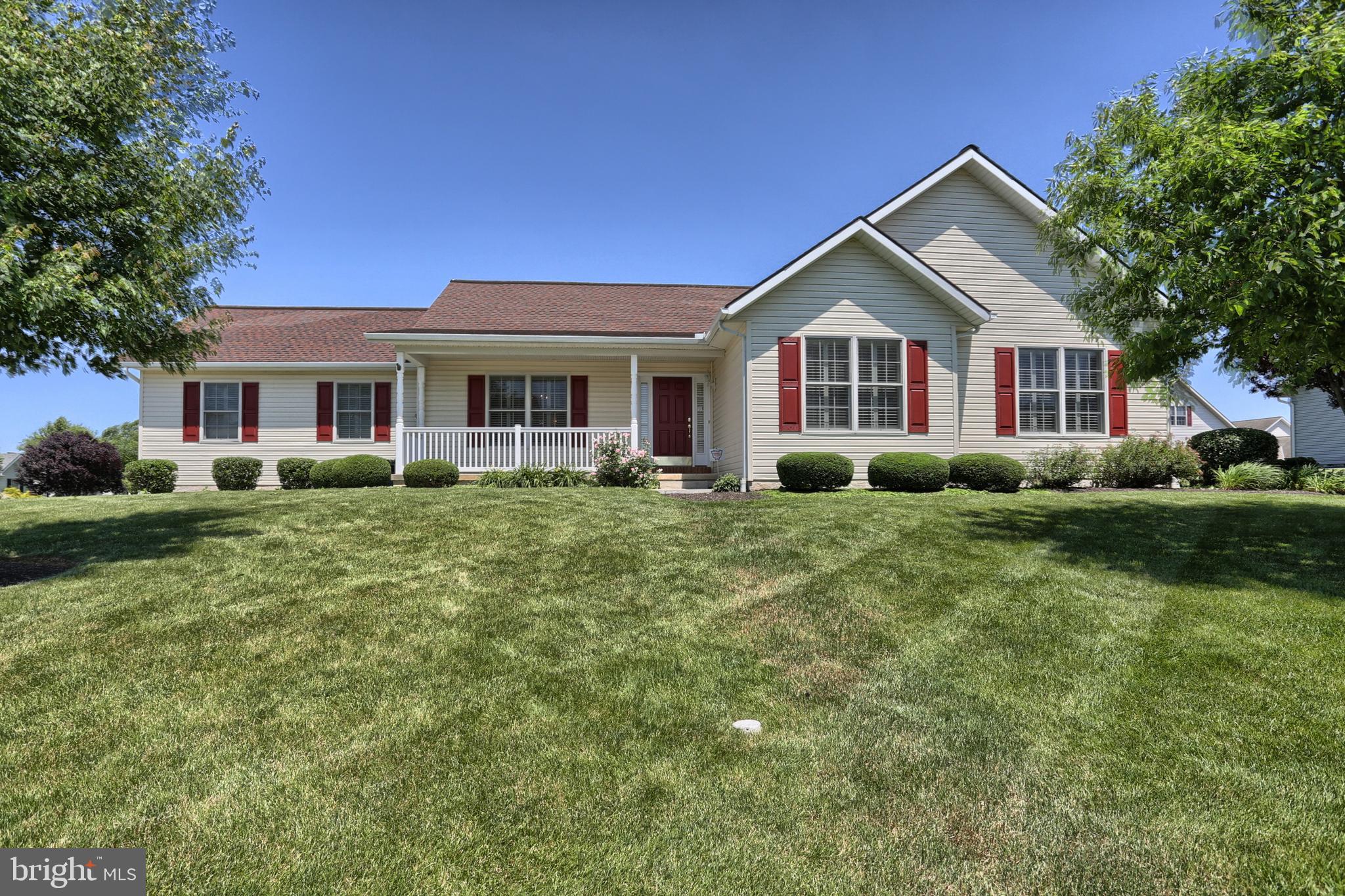 a front view of house with yard and green space