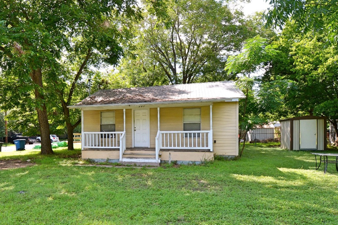 a front view of a house with a garden