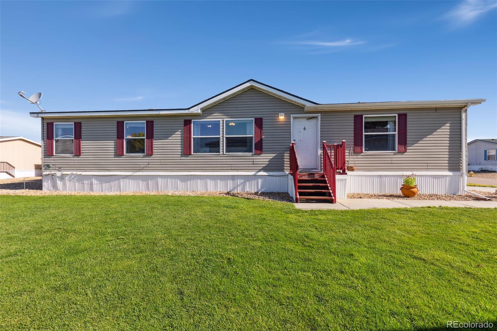 a front view of house with yard and outdoor seating