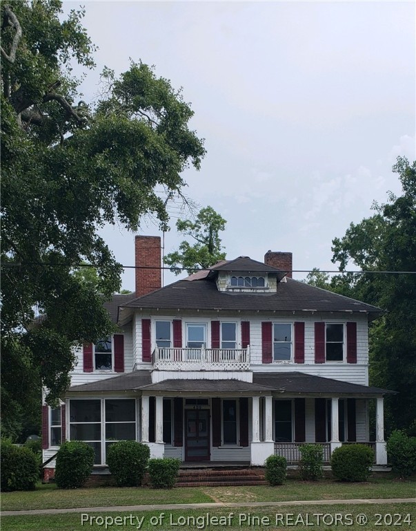 a front view of a building with trees