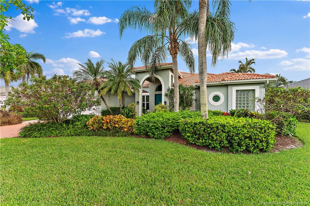 a front view of house with yard and green space