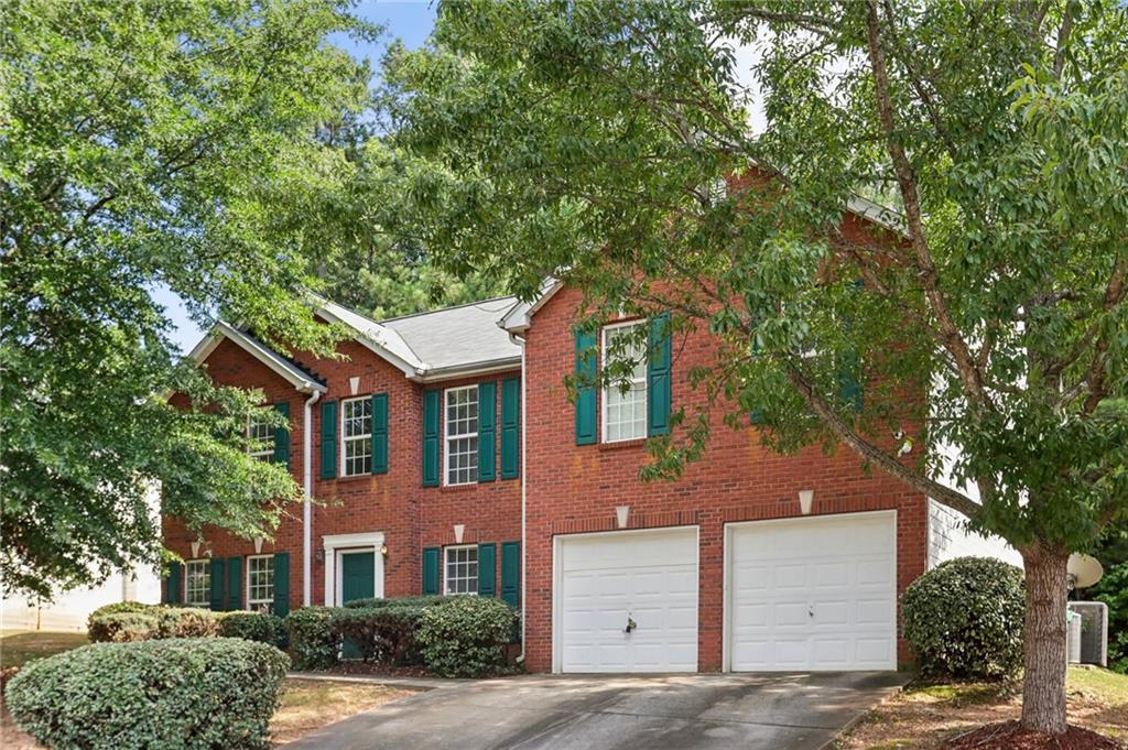 front view of a house with a tree