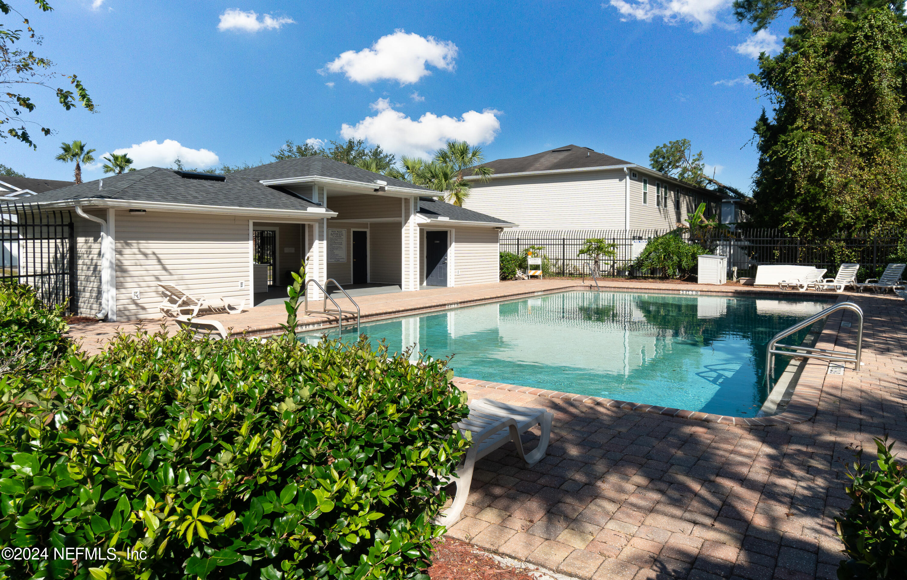 a view of a house with swimming pool and a yard