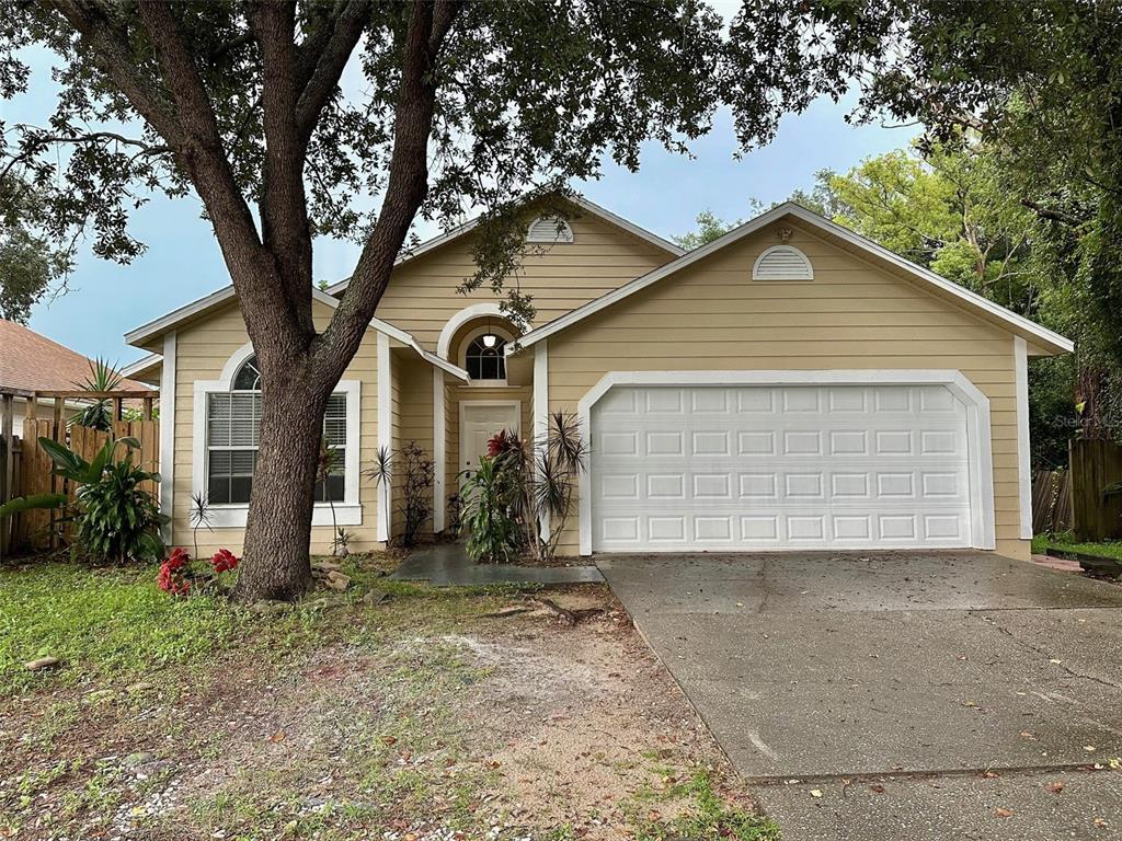 a view of a house with a yard and garage