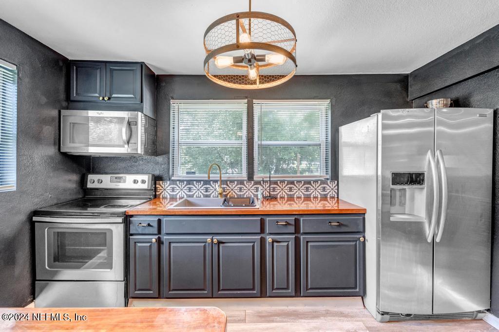 a kitchen with stainless steel appliances granite countertop a stove and a sink