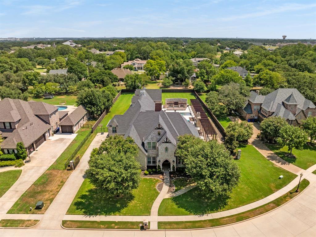 an aerial view of residential houses with outdoor space and swimming pool