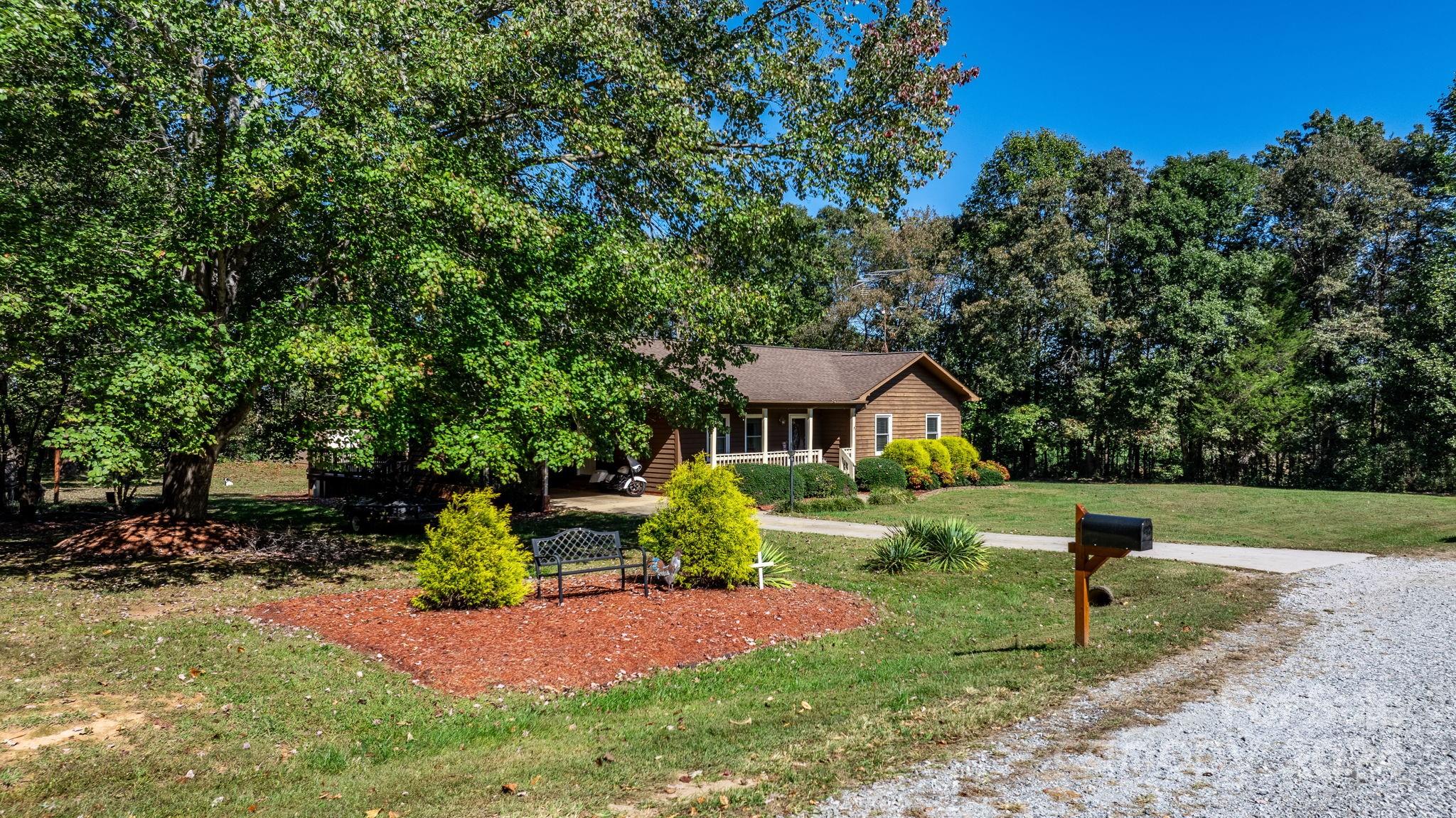 a view of a house with a yard and sitting area