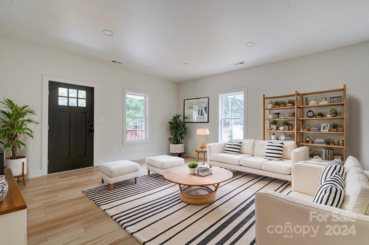 a living room with furniture and wooden floor