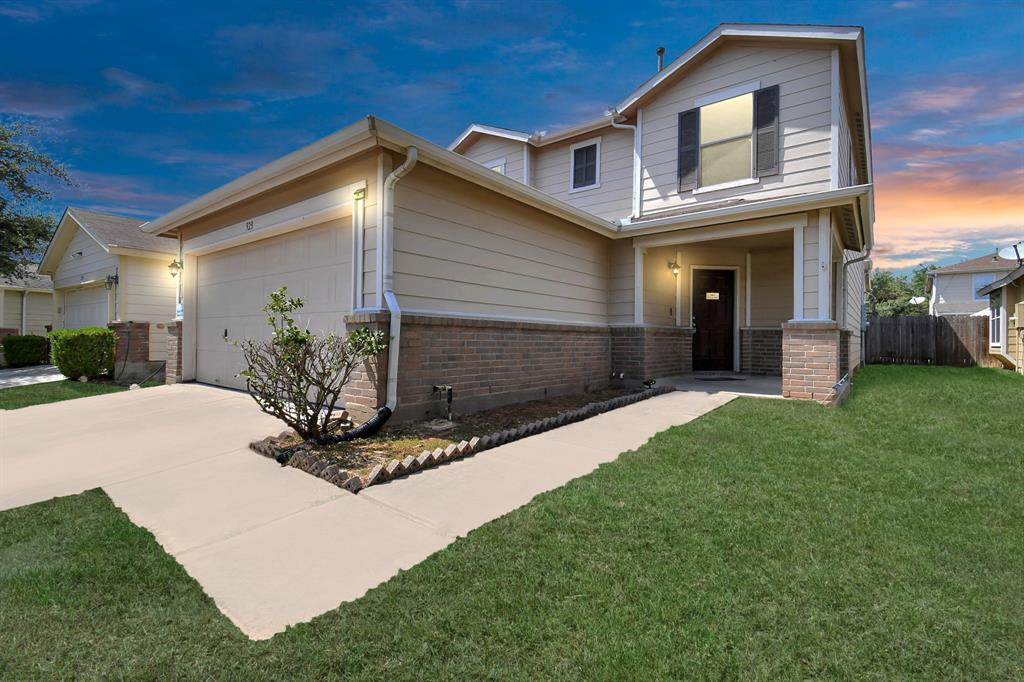 a front view of a house with a yard and garage