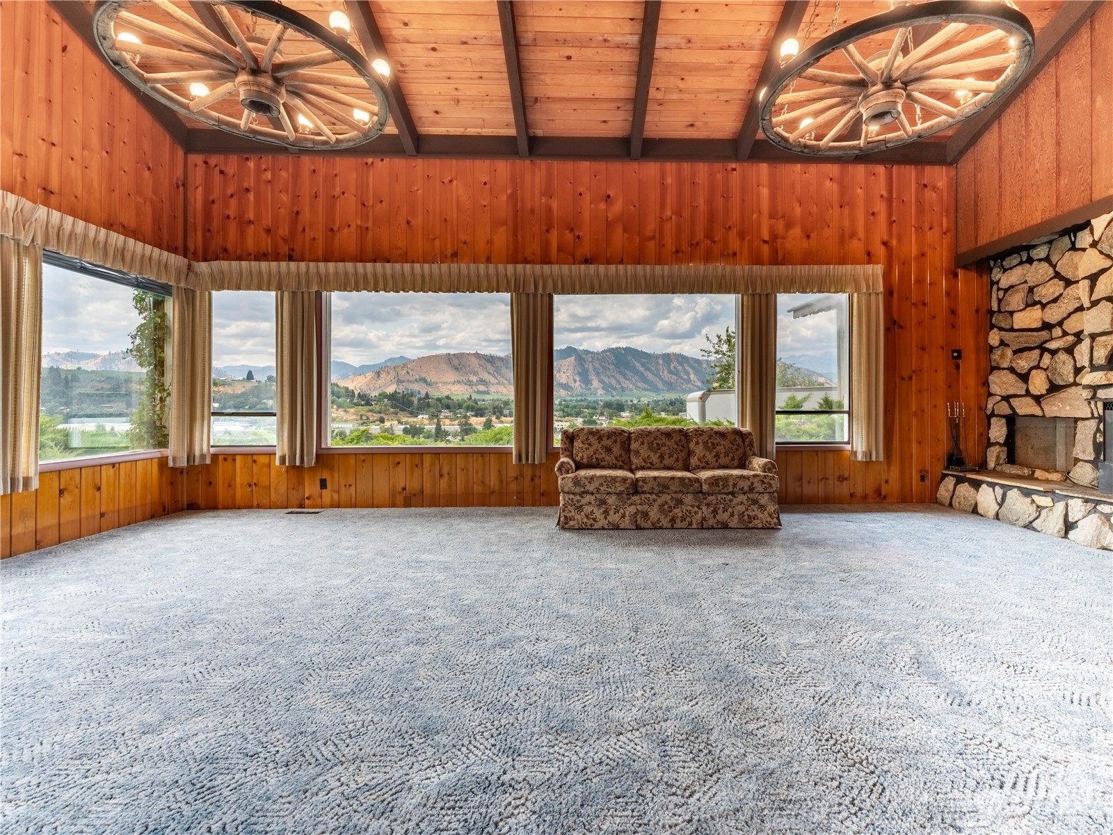 a view of a room with a large window and couches