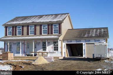 front view of a brick house with a yard