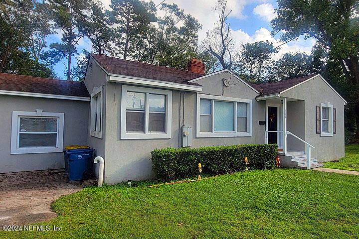 a front view of a house with a garden