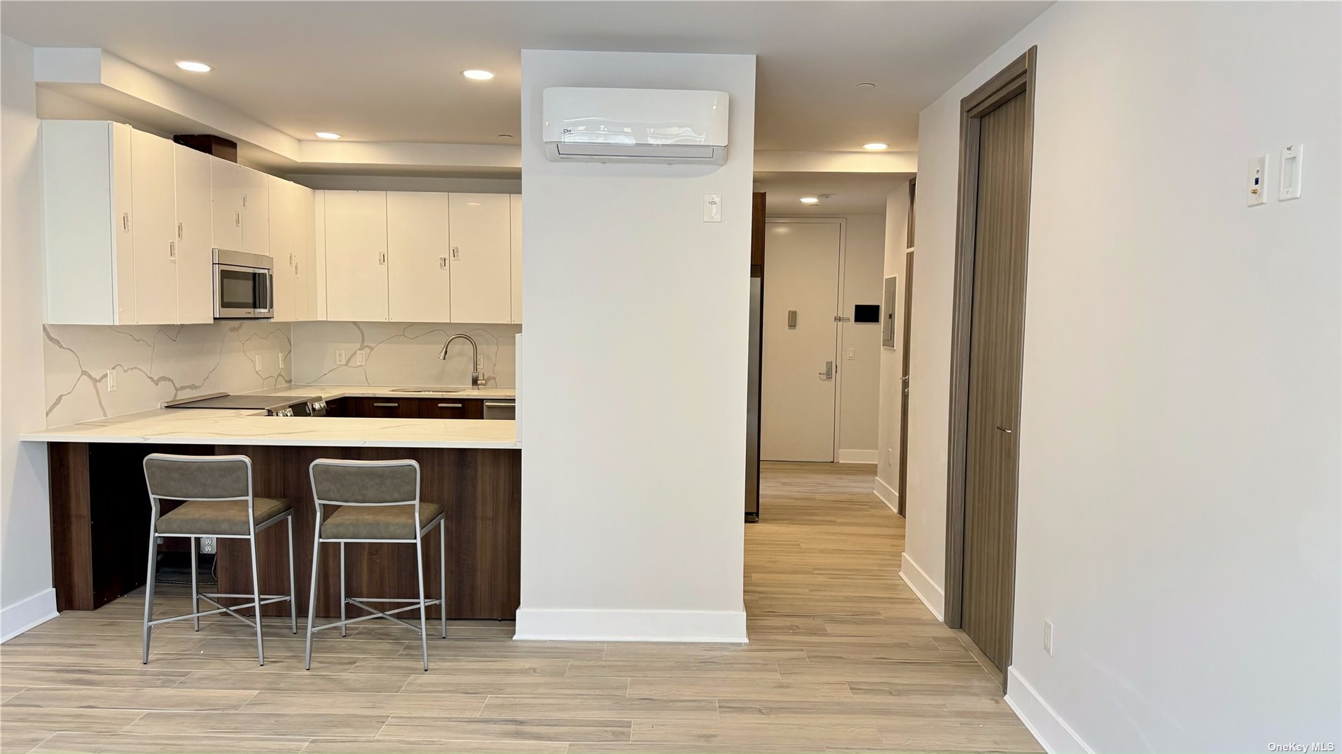 a view of kitchen with granite countertop cabinets and white appliances