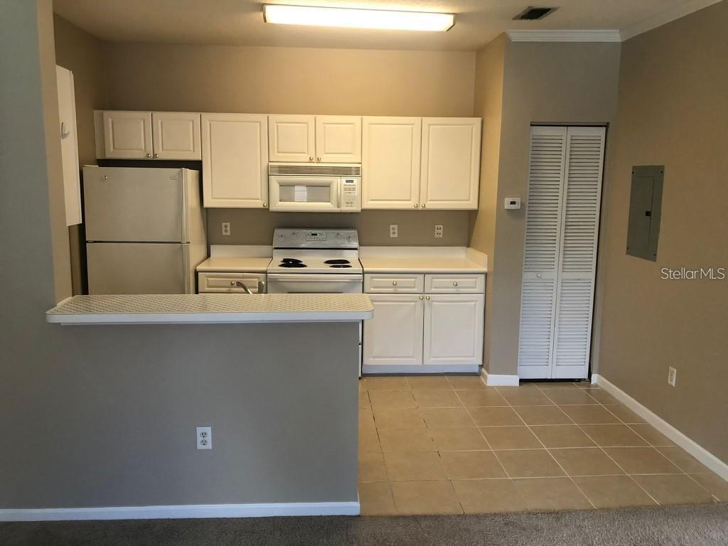 a kitchen with stainless steel appliances a stove a sink and a refrigerator