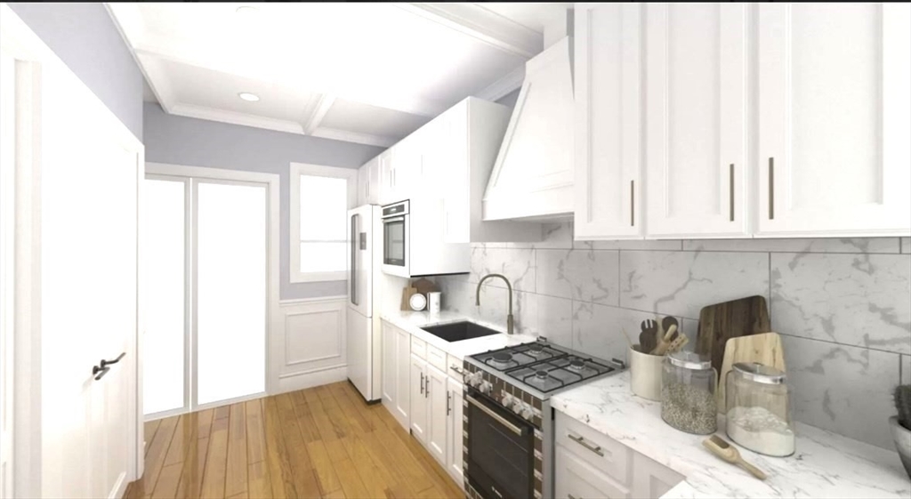 a kitchen with granite countertop a sink stove and cabinets