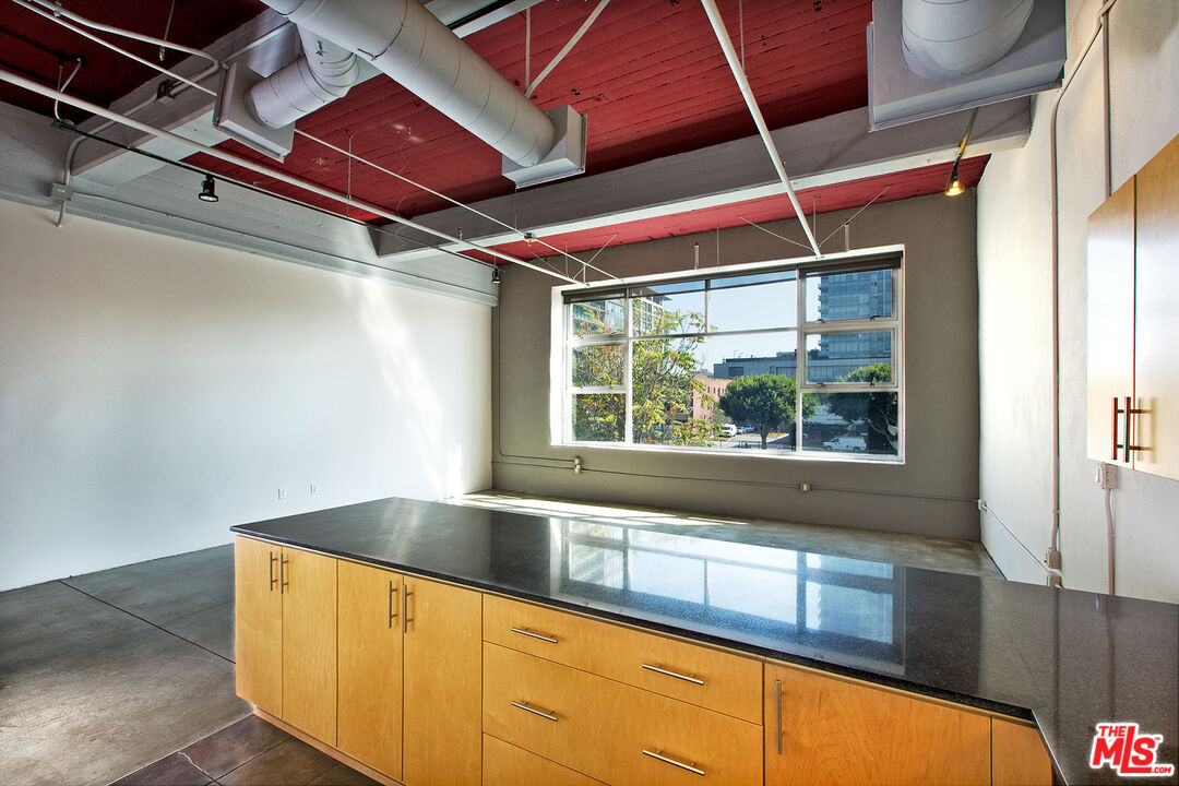 a view of a room with wooden floor and windows