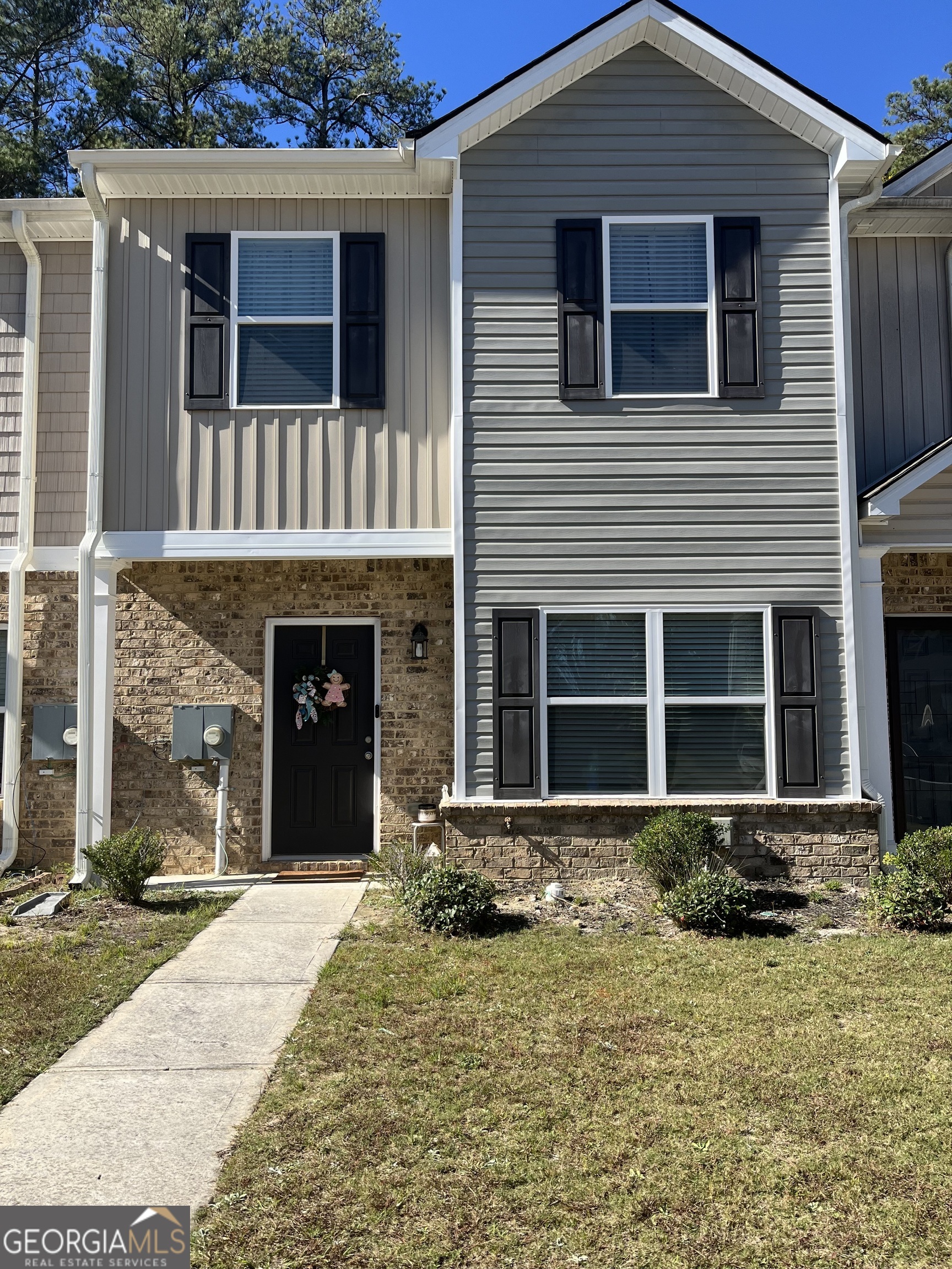 a front view of a house with a yard