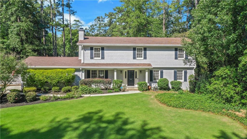 a aerial view of a house with garden and porch