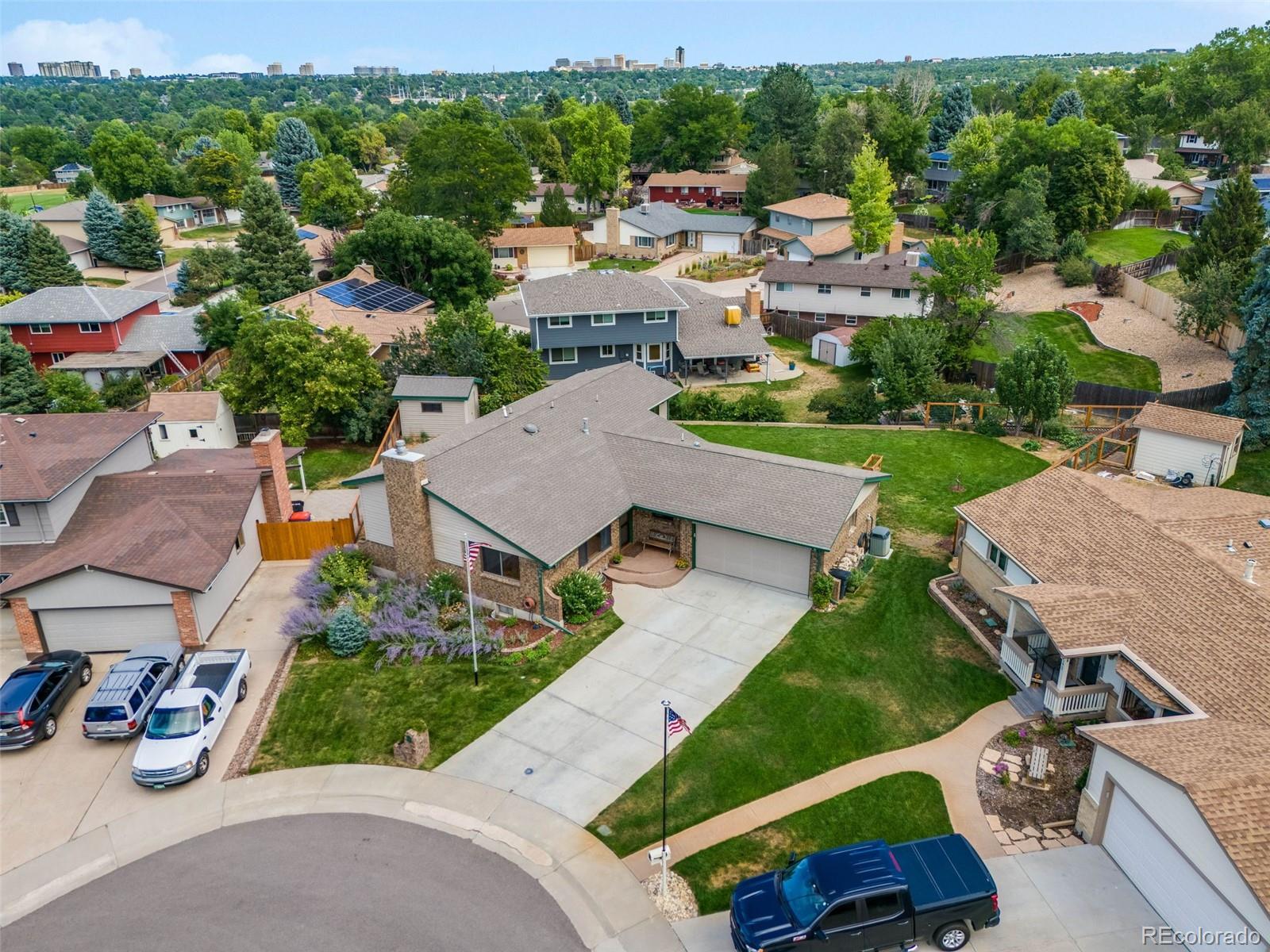 an aerial view of a house with garden space and street view