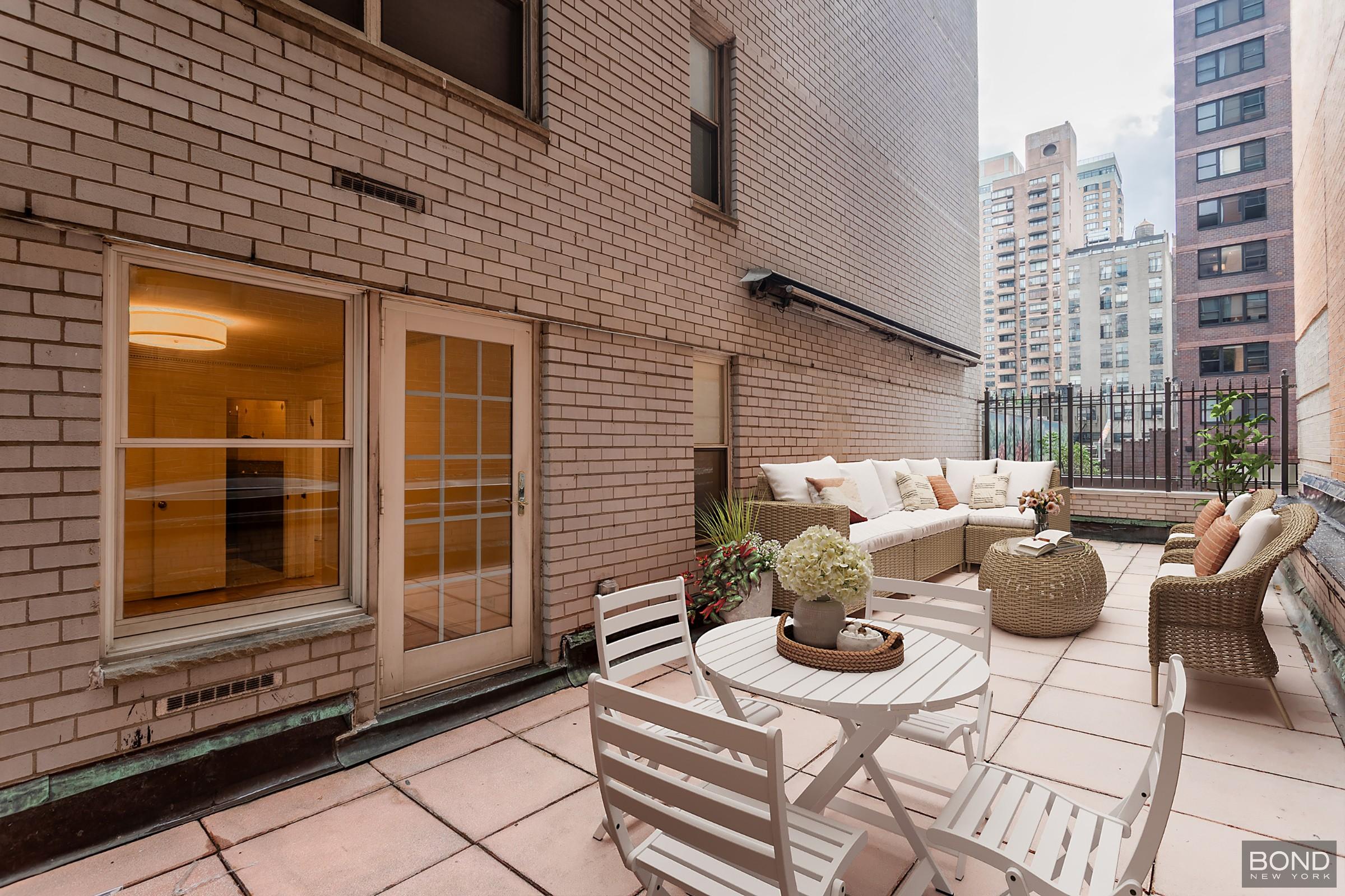 a view of a patio with couches and potted plants