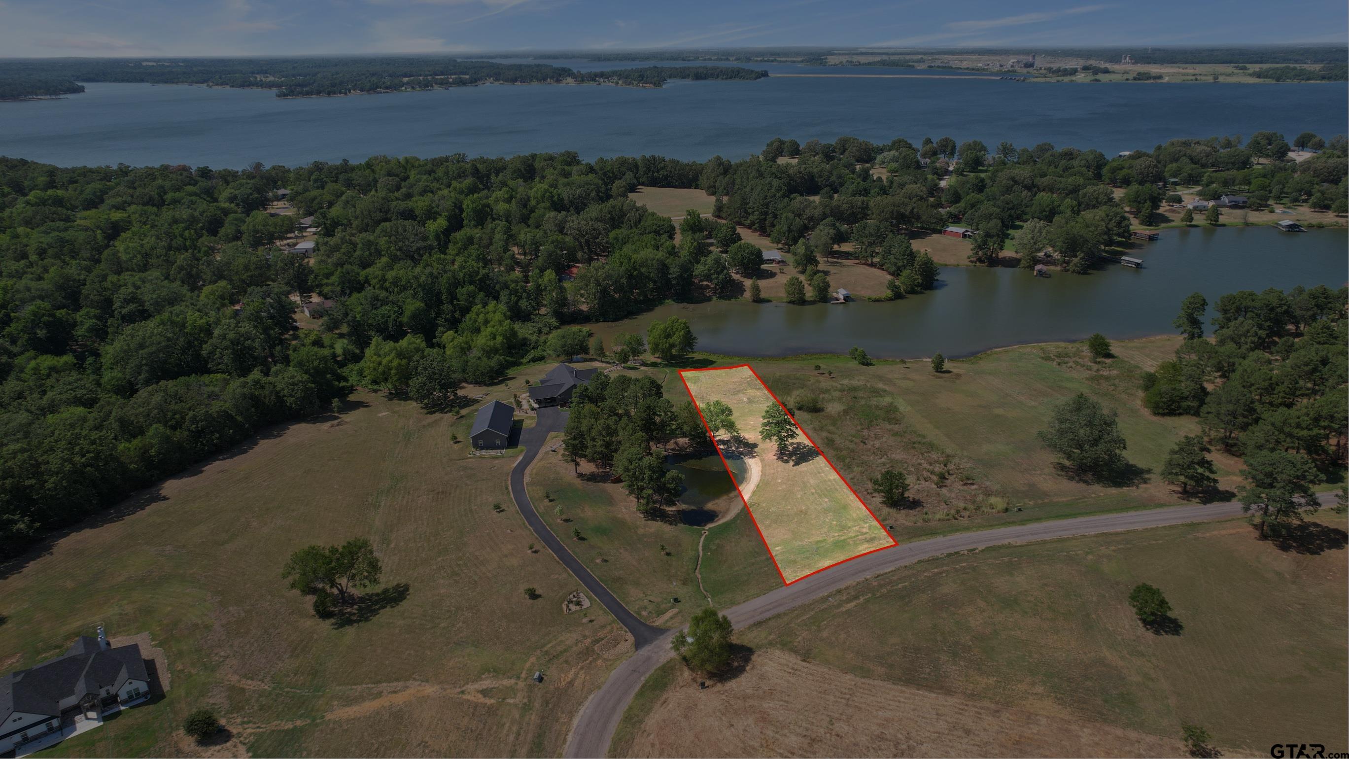 an aerial view of a house with lake view