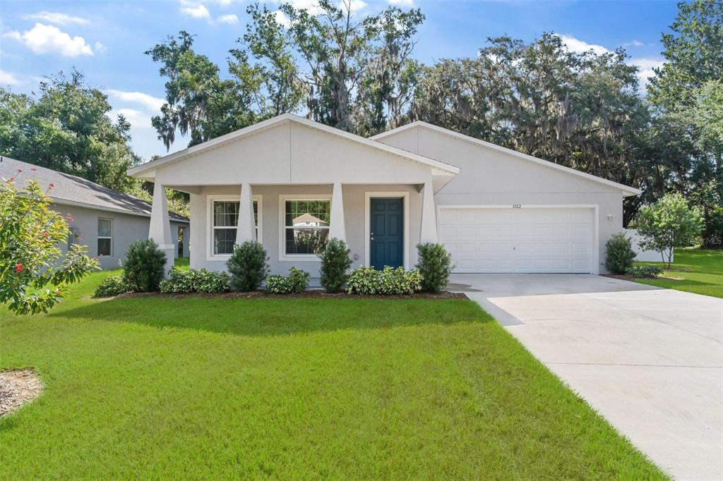 a front view of a house with garden