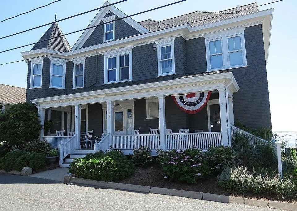 a front view of a building with potted plants