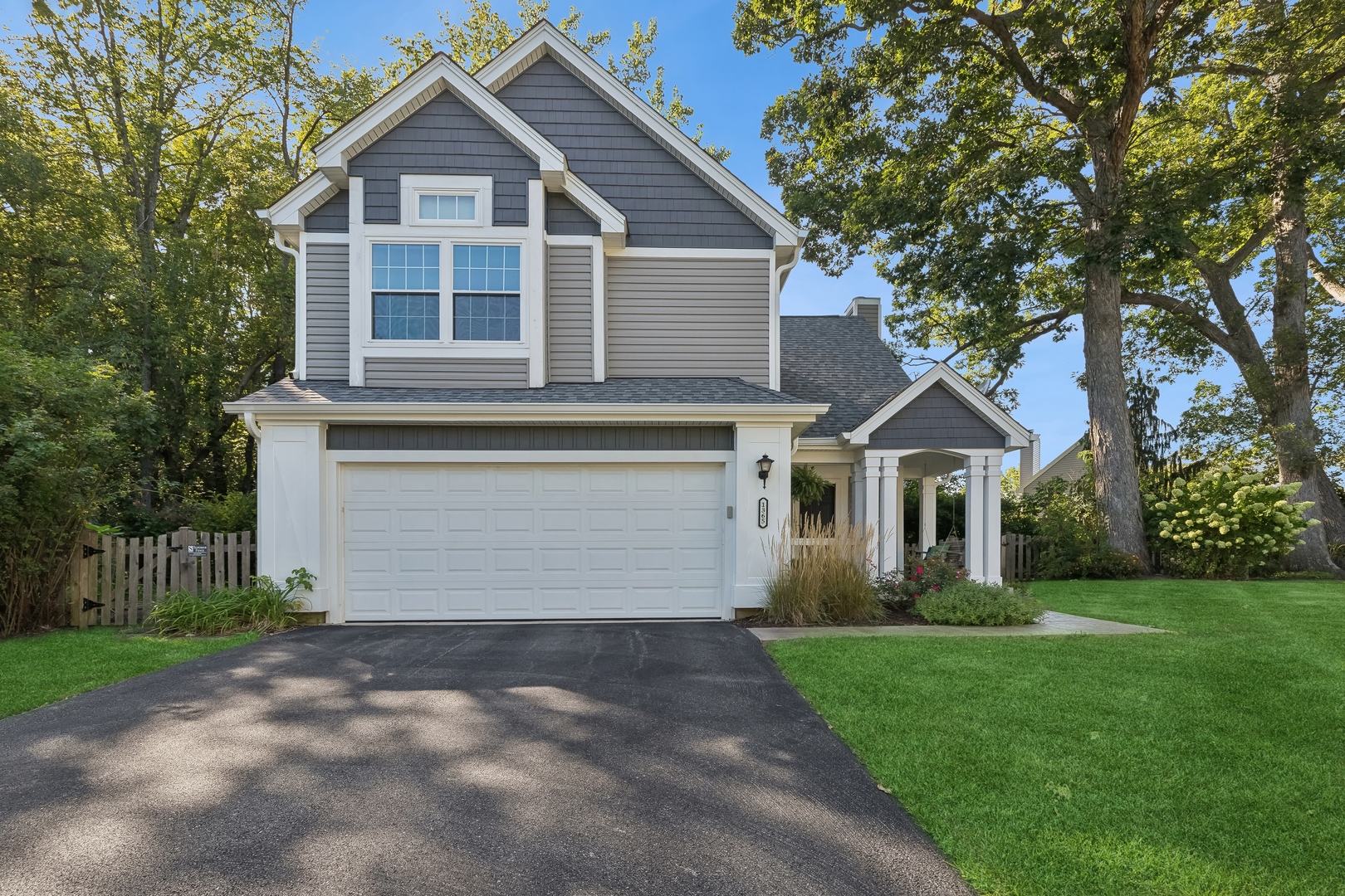 a front view of a house with a garden and yard