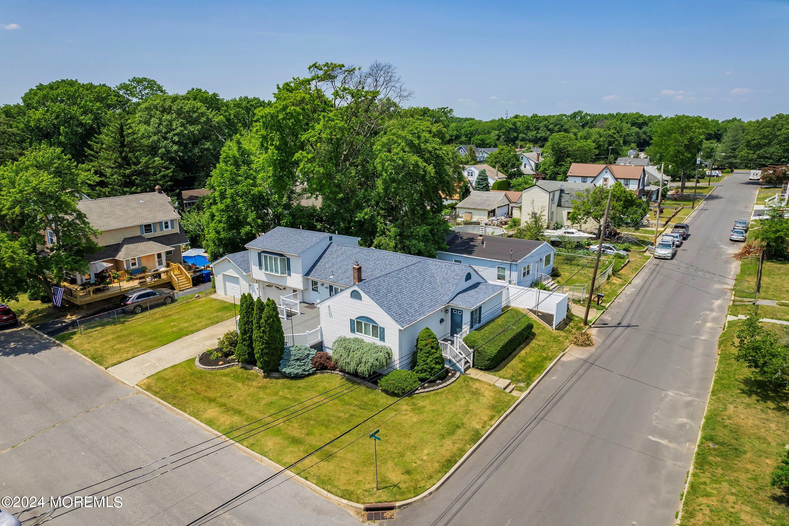 an aerial view of a house with garden space and street view