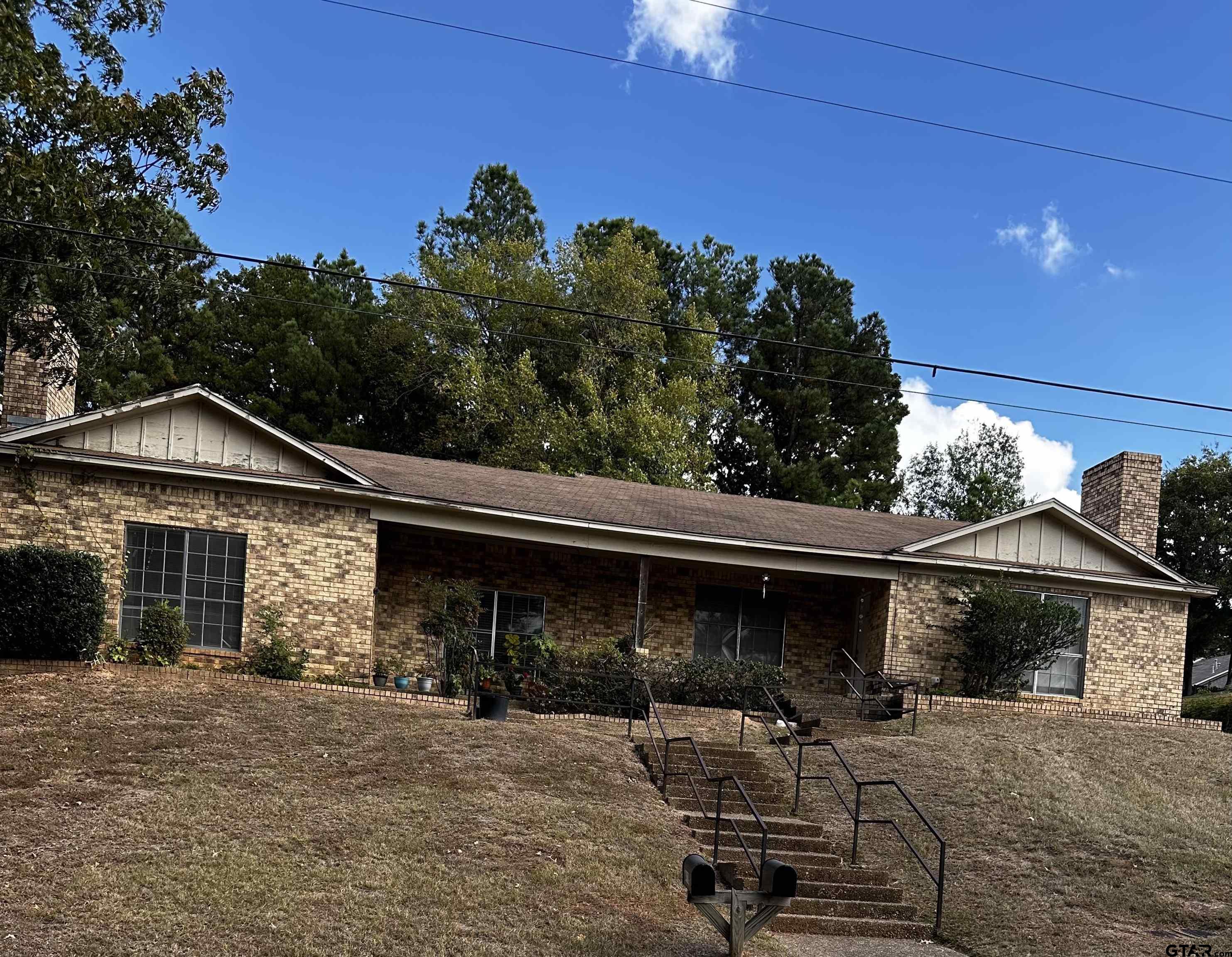 a view of a house with backyard and sitting area