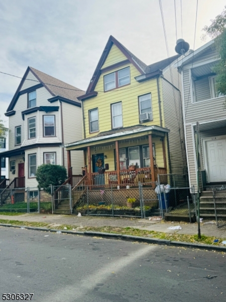 a front view of a residential apartment building with a yard