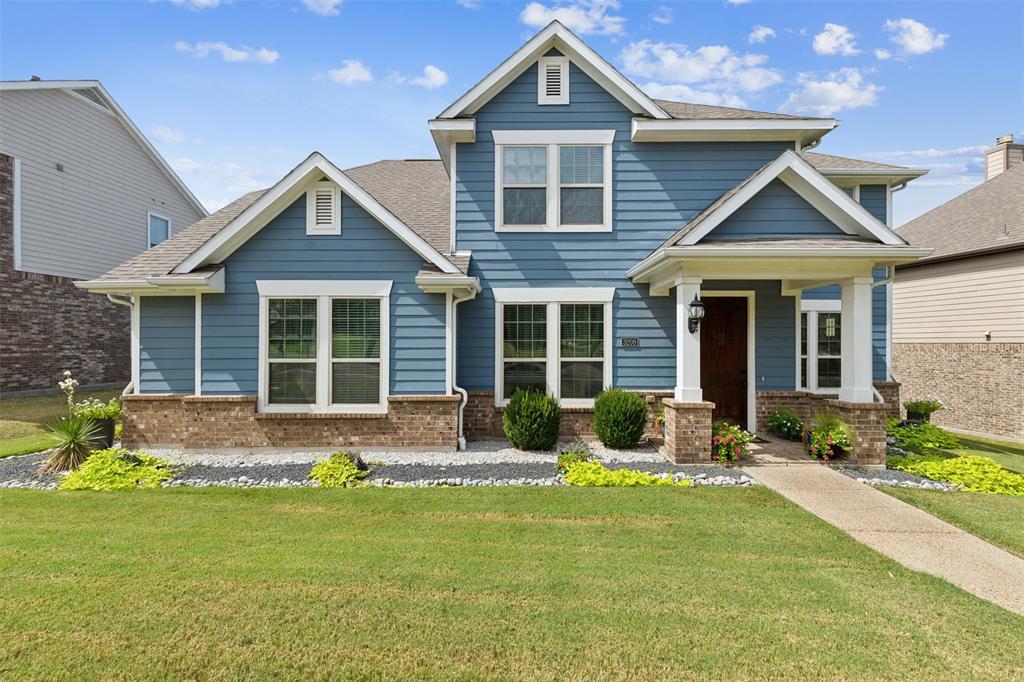 a front view of a house with a yard and outdoor seating