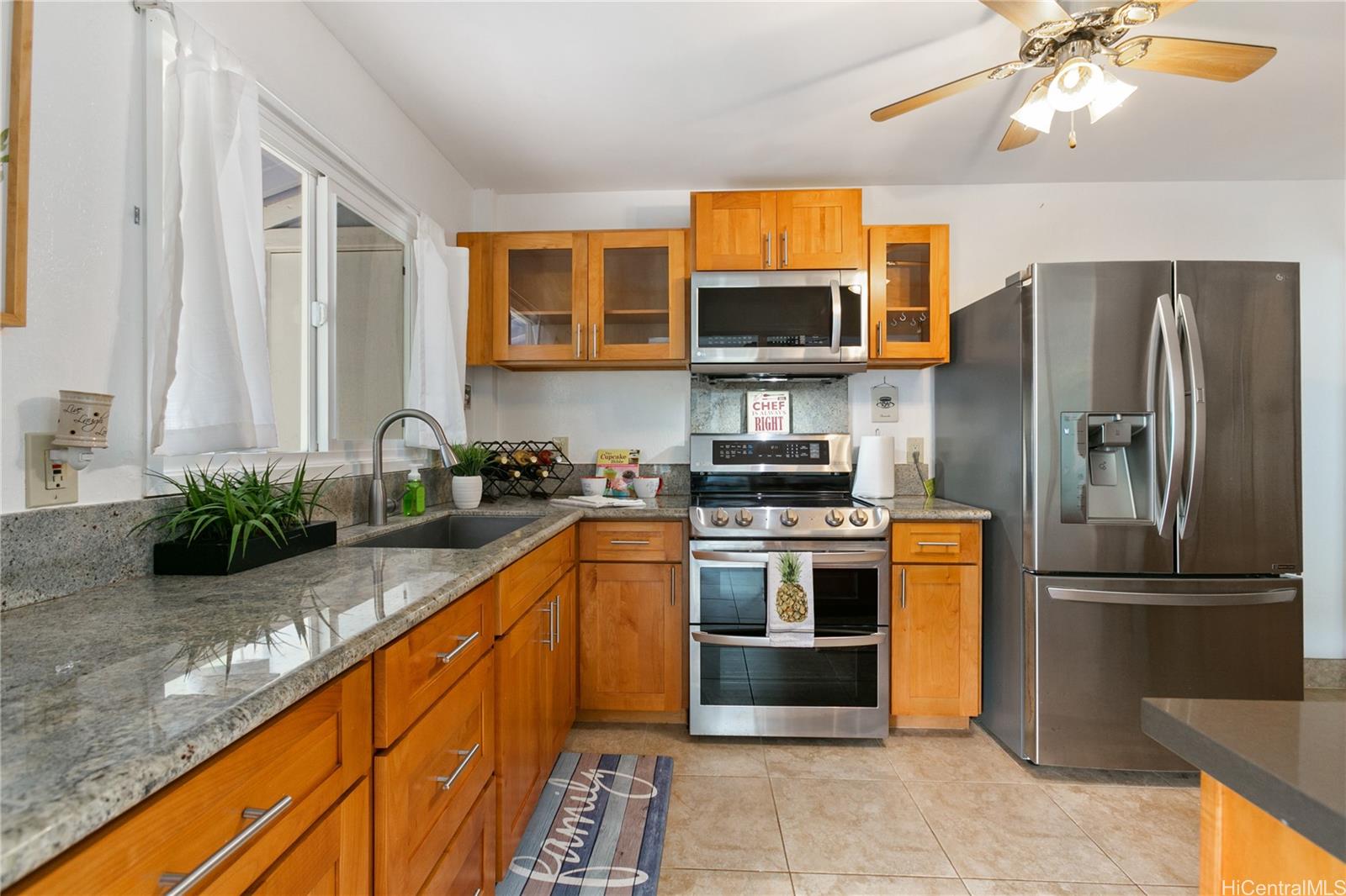 a kitchen with stainless steel appliances granite countertop a refrigerator and a sink