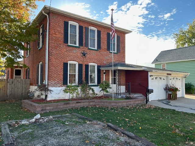 a front view of a house with garden