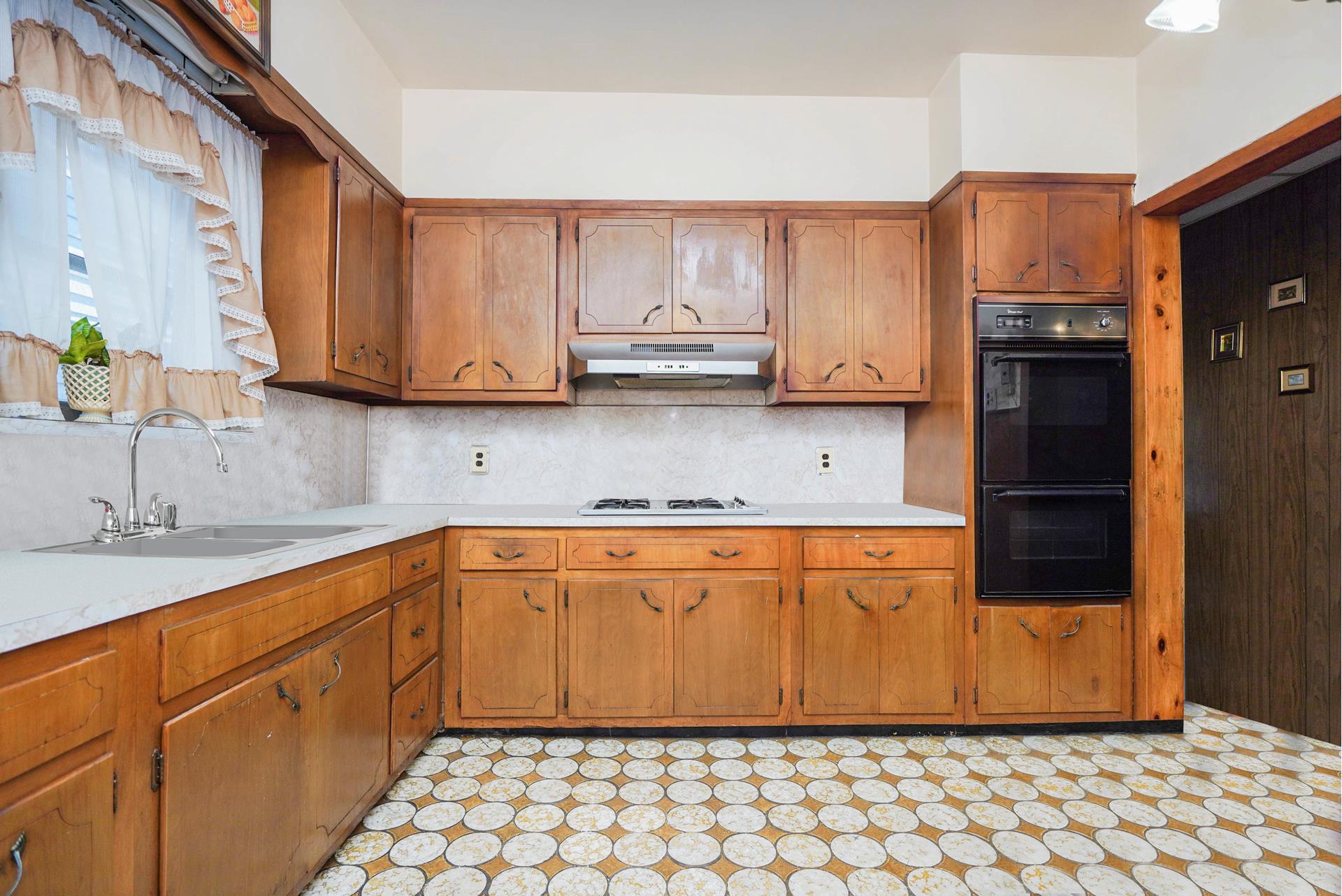 a kitchen with stainless steel appliances granite countertop a refrigerator sink and cabinets