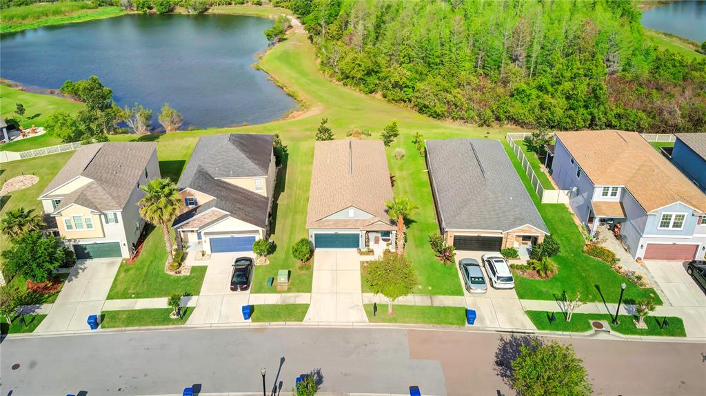 an aerial view of residential houses with outdoor space and street view