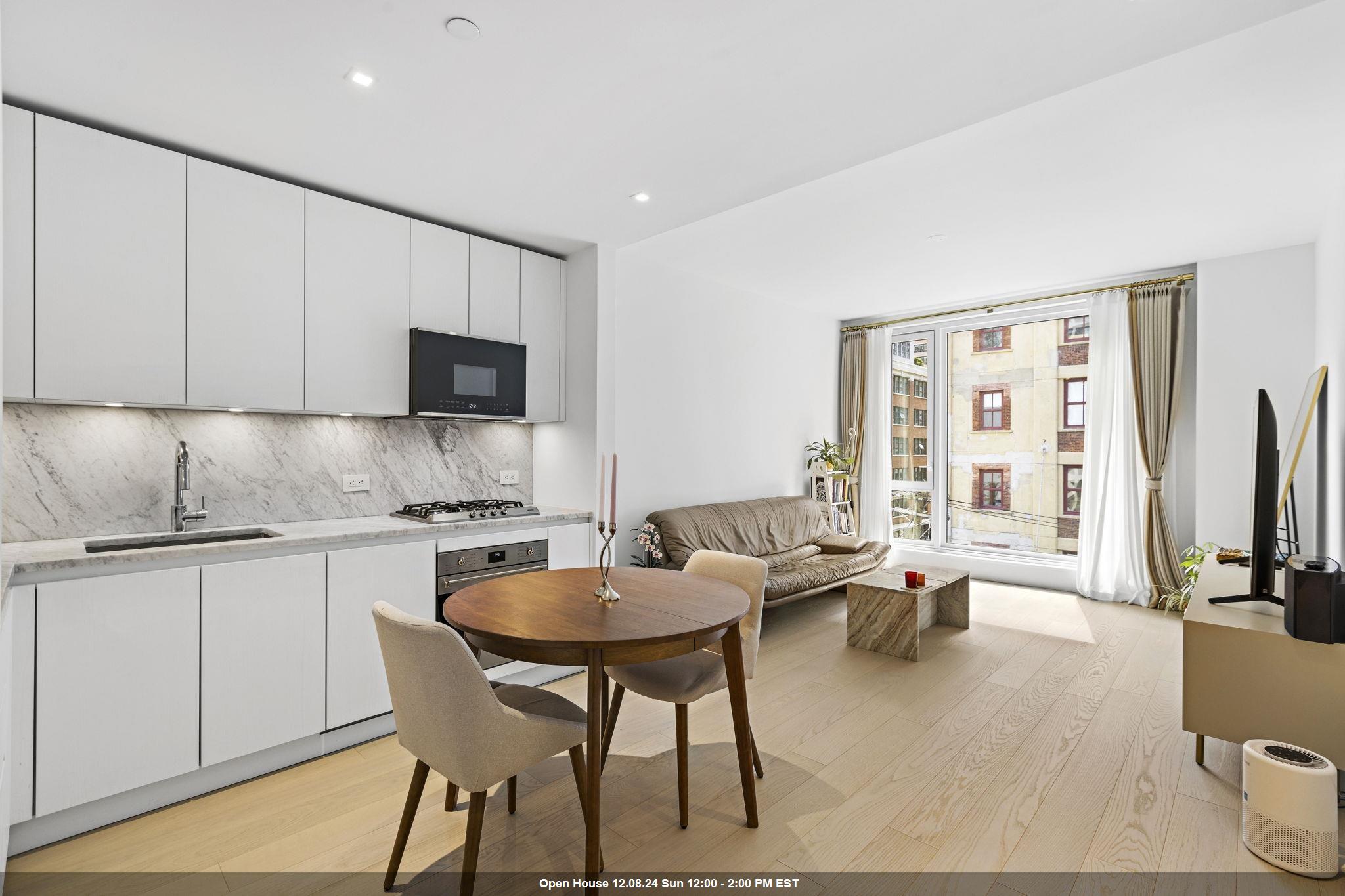 a kitchen with granite countertop white cabinets and stainless steel appliances