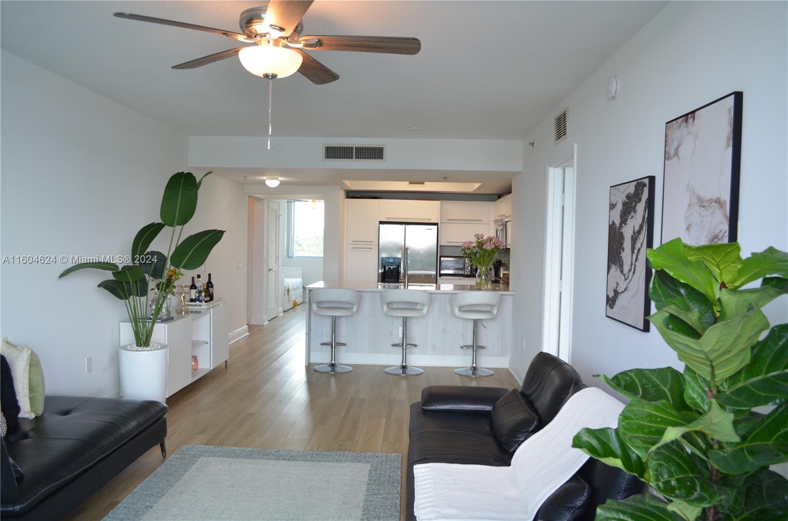 a living room with furniture potted plant and a chandelier