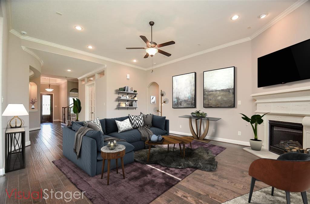 a living room with fireplace furniture and a flat screen tv