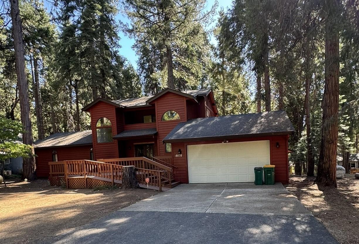 a view of a house with a patio and a yard