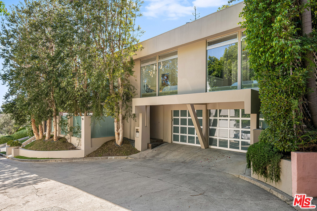 a view of a house with a yard and garage