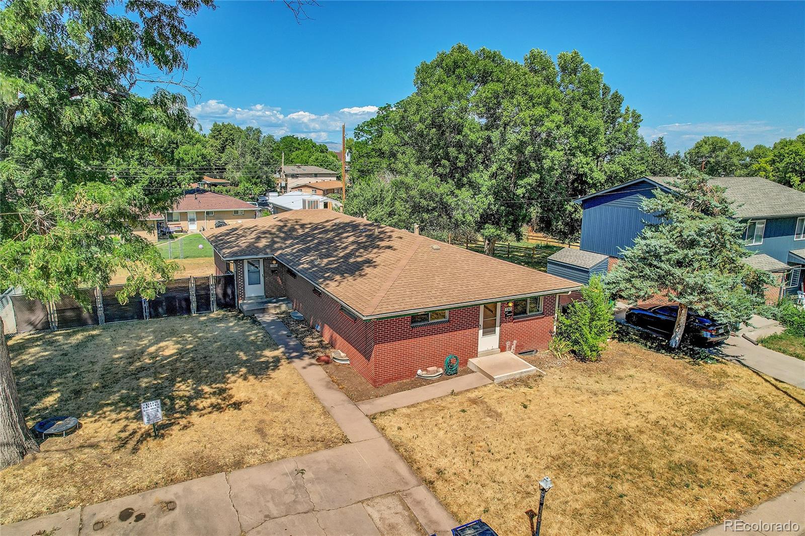 an aerial view of a house with swimming pool and sitting area