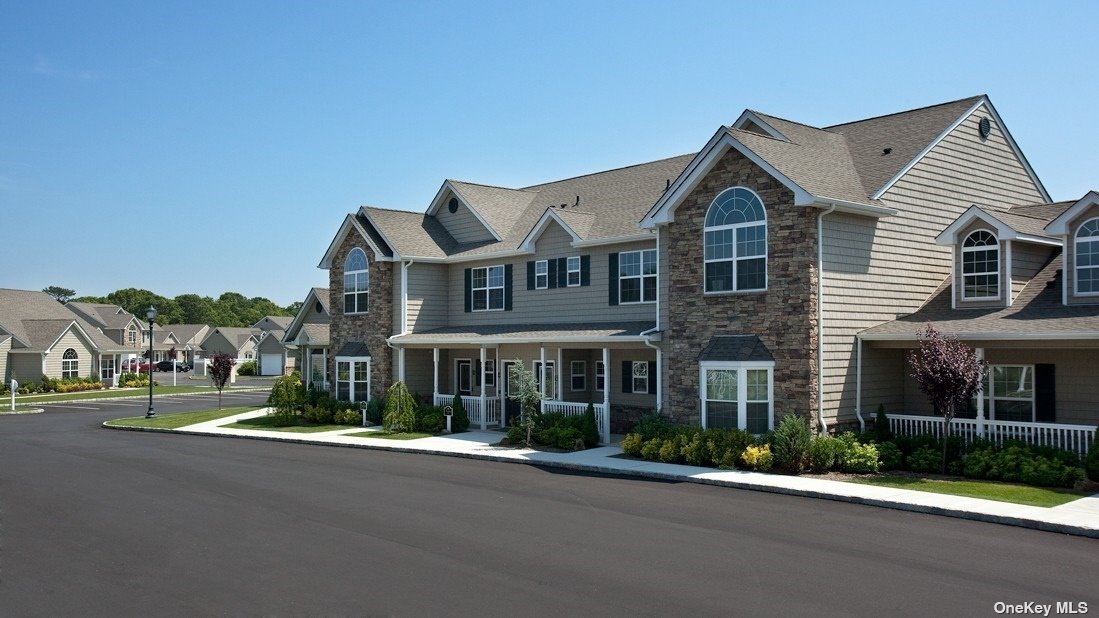 a view of a big house with a yard and plants